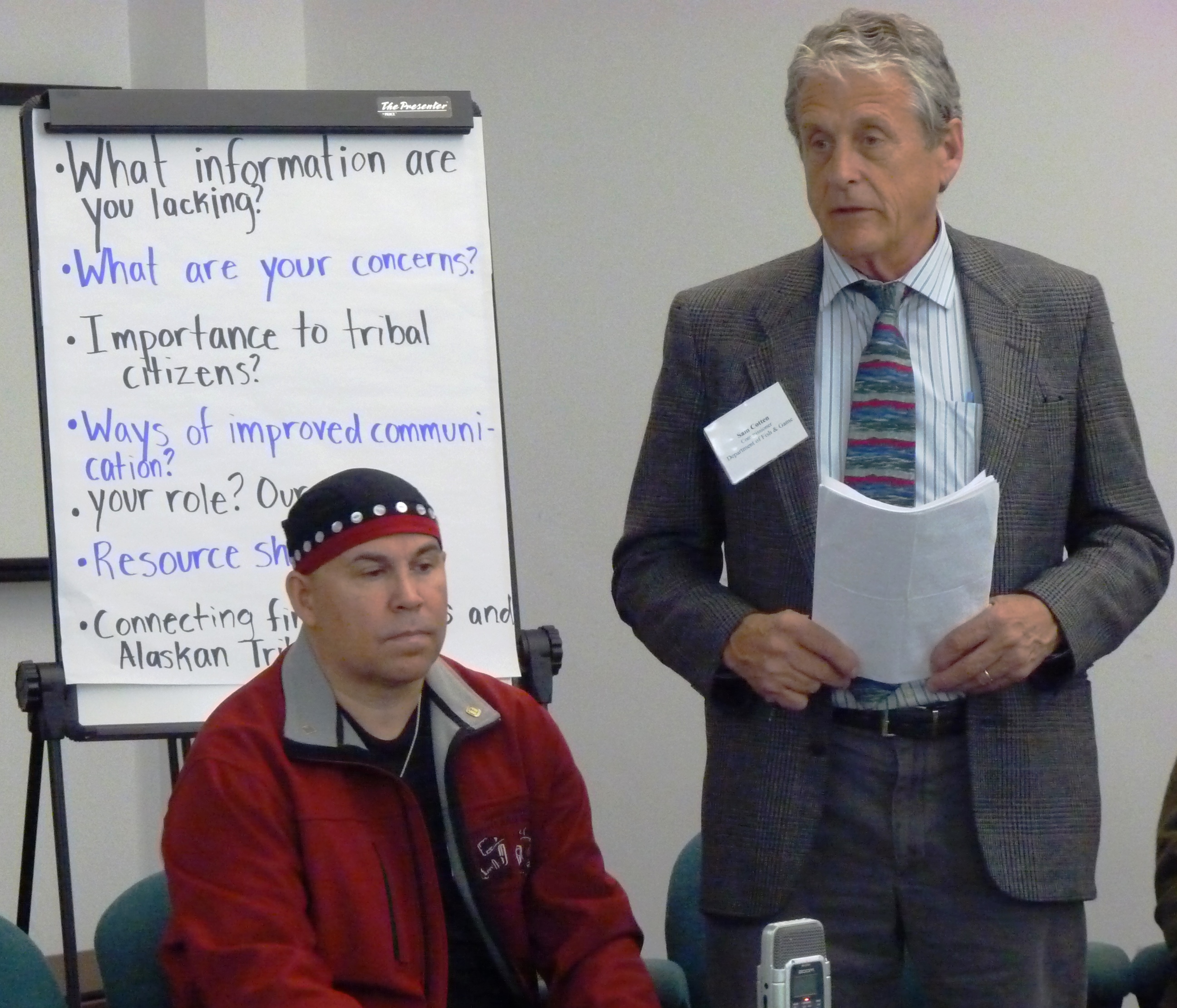 Fish and Game Department Commissioner Sam Cotten speaks while Rob Sanderson Jr. listens during a meeting with tribal leaders in Juneau. ES photos.