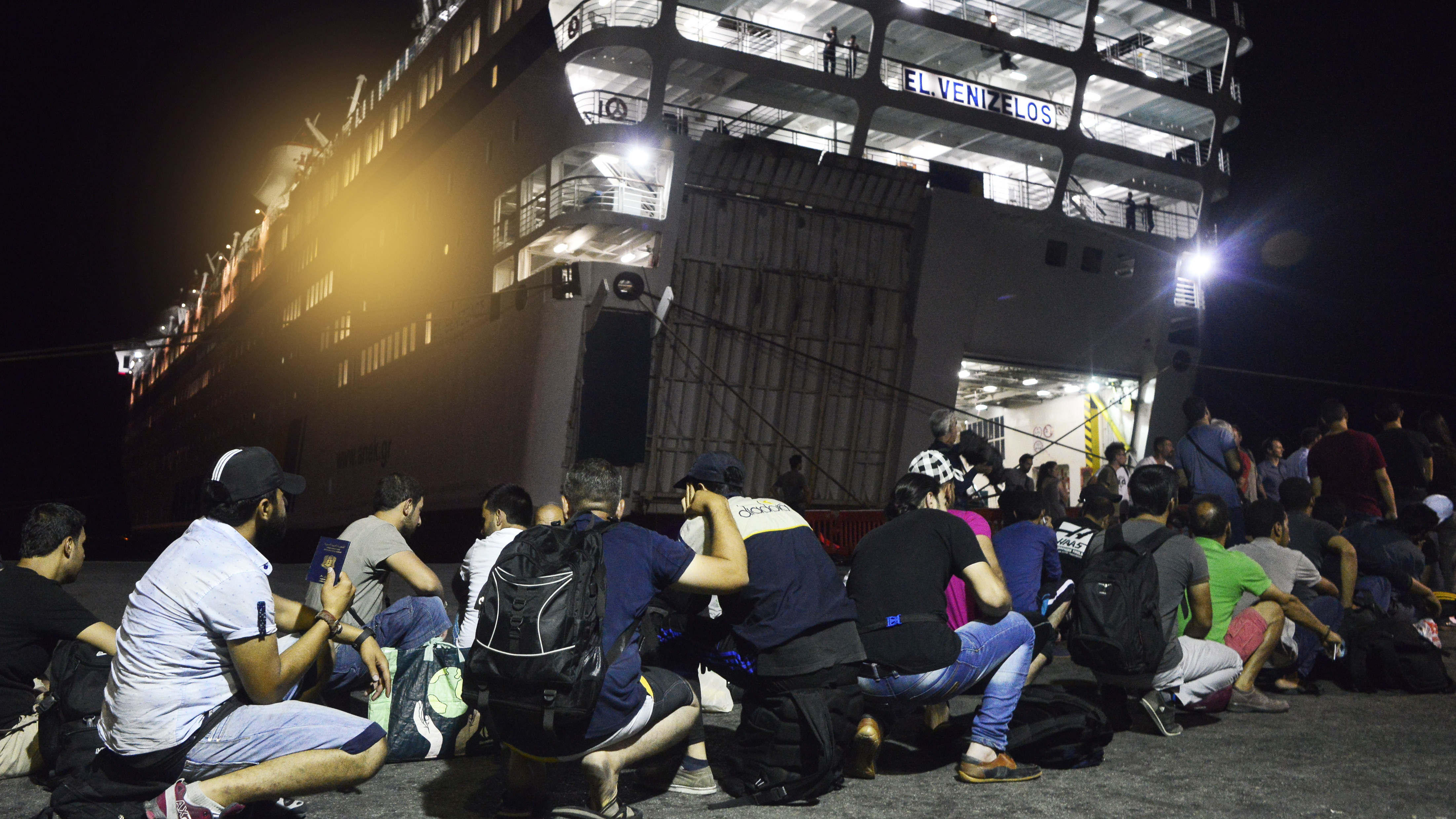 Syrian refugees prepare to board the passenger ship Eleftherios Venizelos at Kos's main port on Sunday in Kos, Greece. The vessel will house more than 2,500 refugees and migrants who entered the country from the Turkish coast. Milos Bicanski/Getty Images