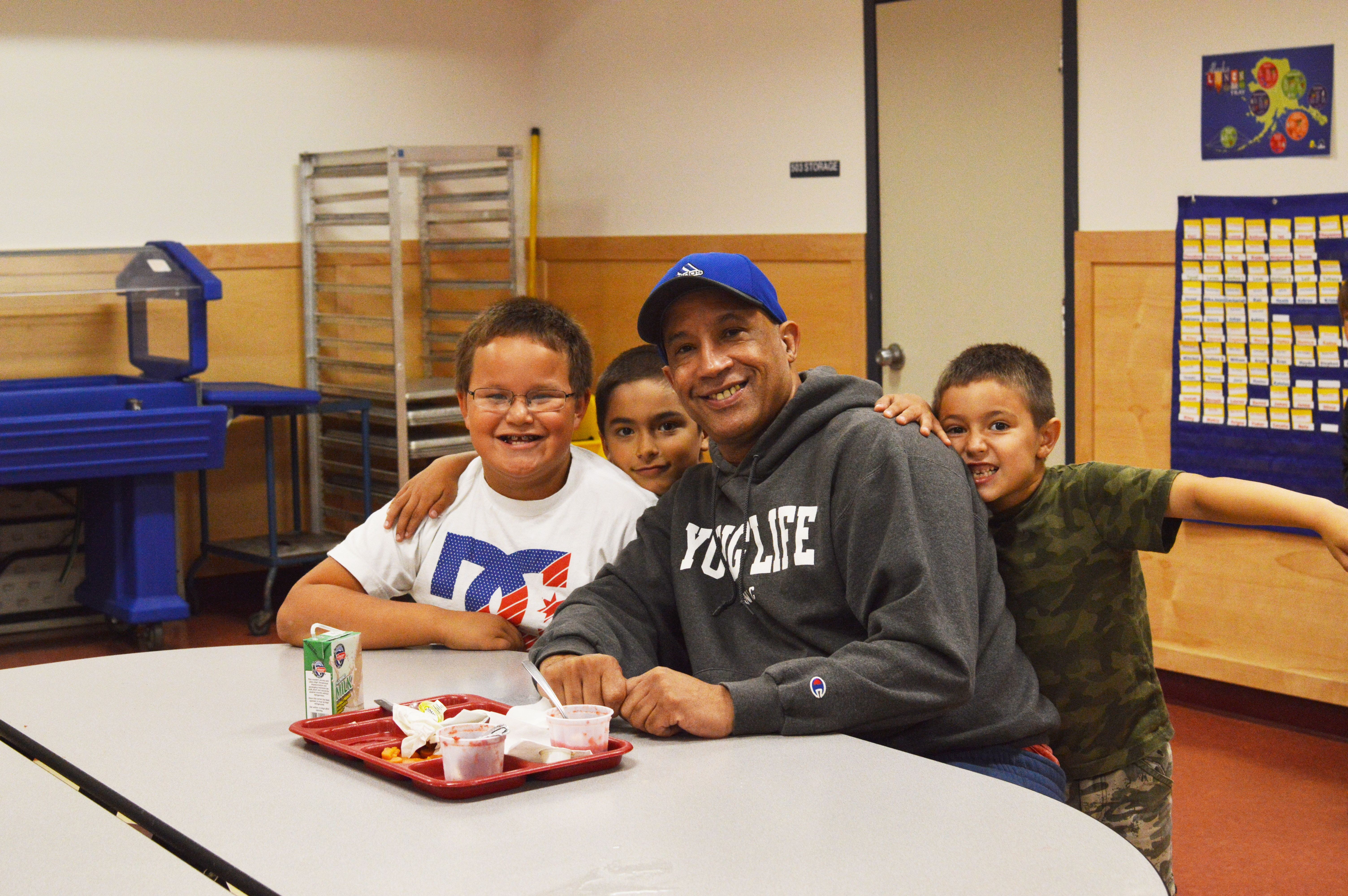 Coach Andy Lee poses with Hoonah kindergartners during their lunch house. (Photo by Lakeidra Chavis/KTOO)