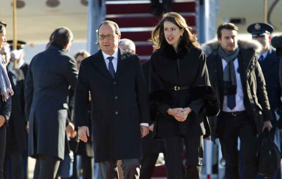 French President François Hollande is accompanied by U.S. Deputy Chief of Protocol Natalie Jones, upon his arrival at Andrews Air Force Base, Md., on Tuesda