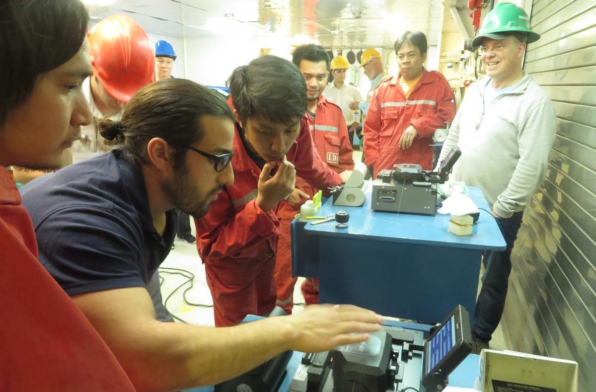 Crew members practice splicing cable on the French vessel. (Photo by Laura Kraegel/KUCB)