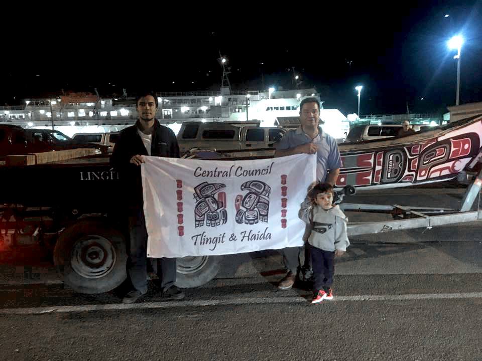 Doug Chilton and DeAndre King in front of the canoe they're transporting to North Dakota. (Photo courtesy of Central Council of Tlingit and Haida Indian Tribes of Alaska)