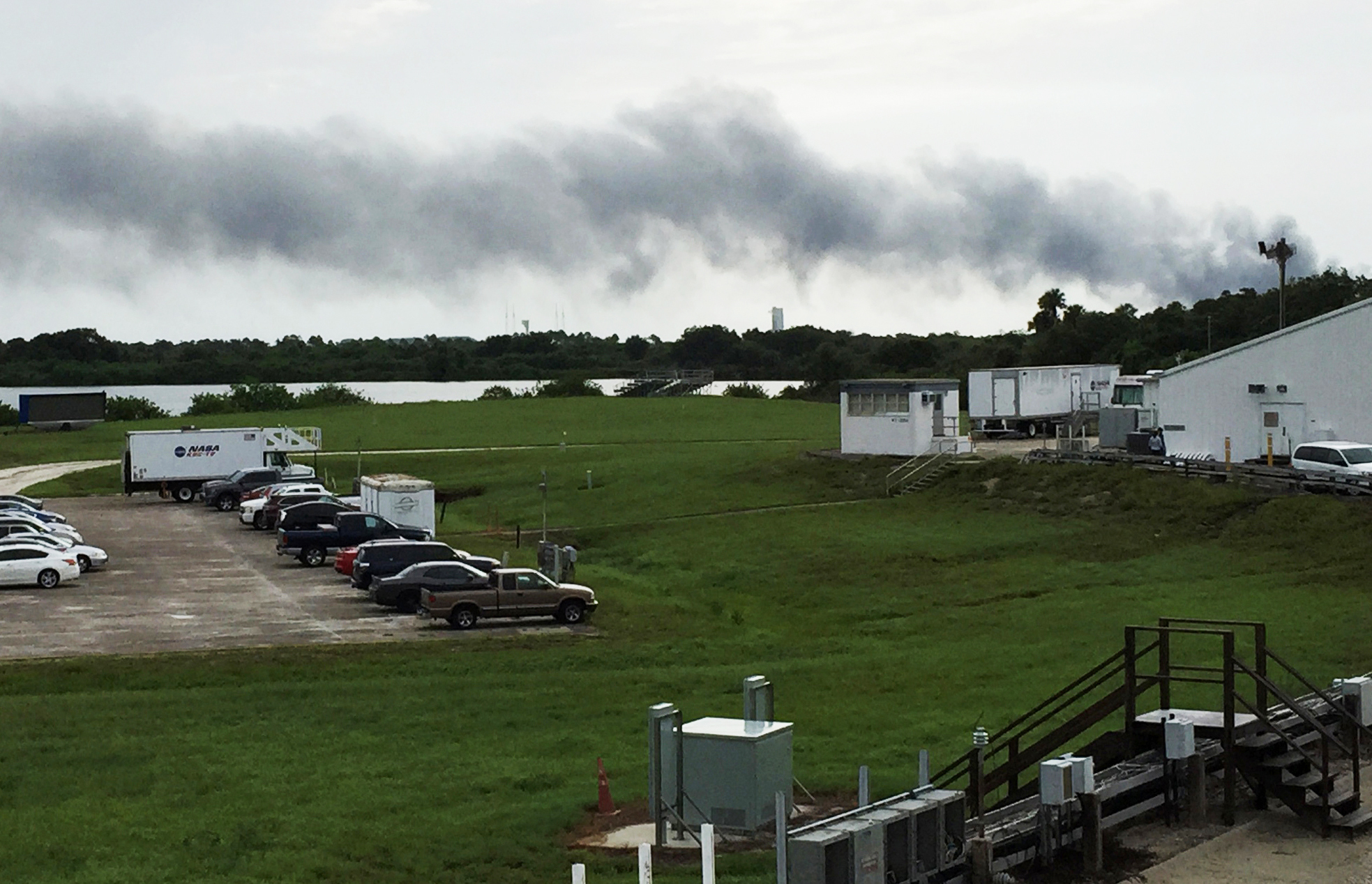 Smoke rises from a SpaceX launch site at Cape Canaveral, Fla., on Thursday. NASA said SpaceX was conducting a test firing of its unmanned rocket when a blast occurred. (Photo by Marcia Dunn/Associated Press)