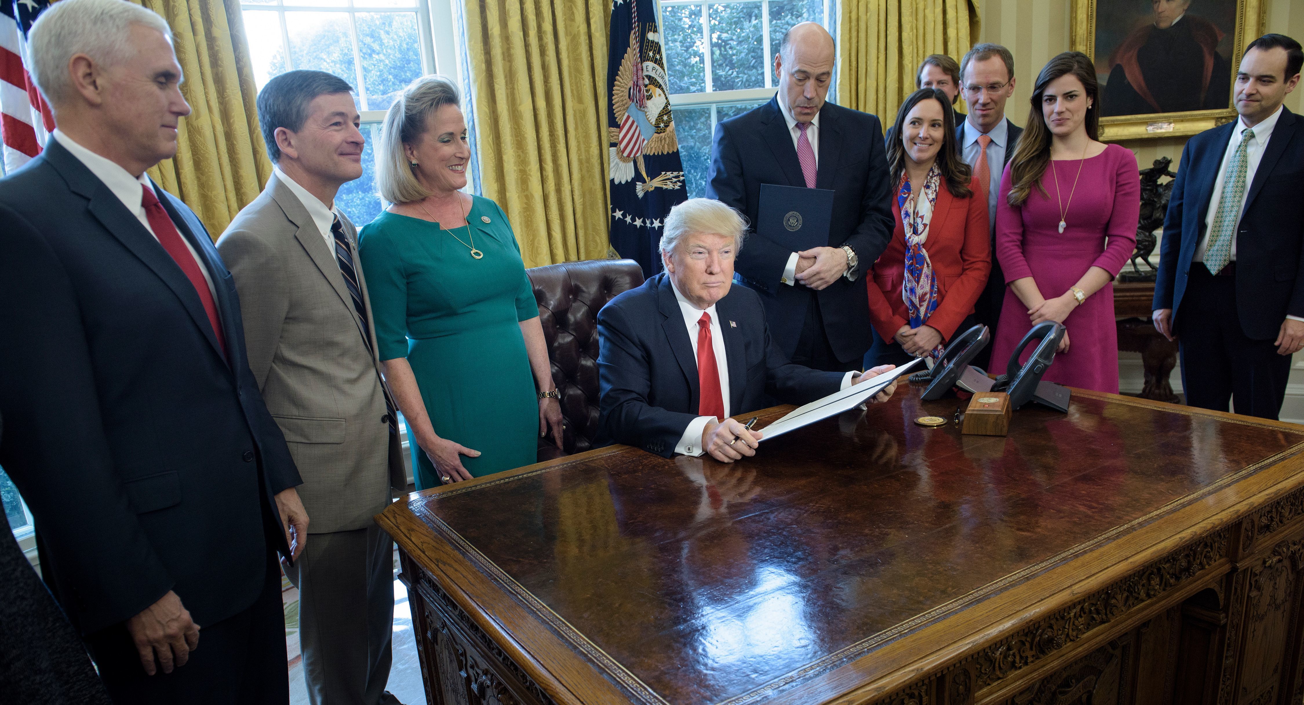 Trump takes aim at Dodd-Frank, investor protections rule in executive action