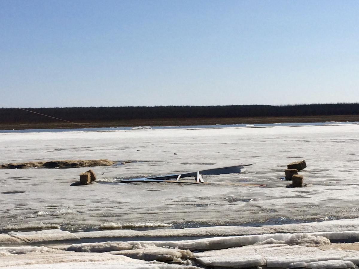 Bettors wait for the Kuskokwim Ice Classic Tripod to stop the clock