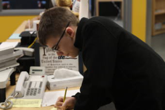 Jack Pellerin prepares his morning weather broadcast script (Photo by Wesley Early/Alaska Public Media)
