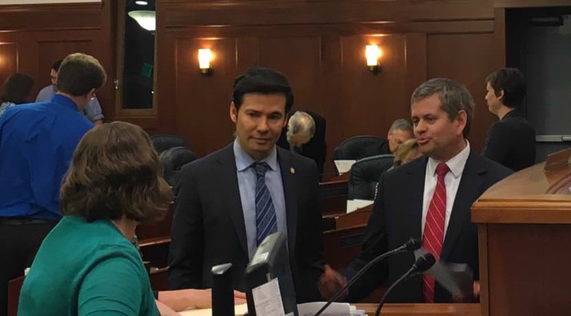 Rep. Neil Foster, D-Nome, and Rep. Chris Tuck, D-Anchorage, talk before the vote on the capital budget. The budget passed, 27-13, July 27, 2017. (Photo by Andrew Kitchenman/KTOO)