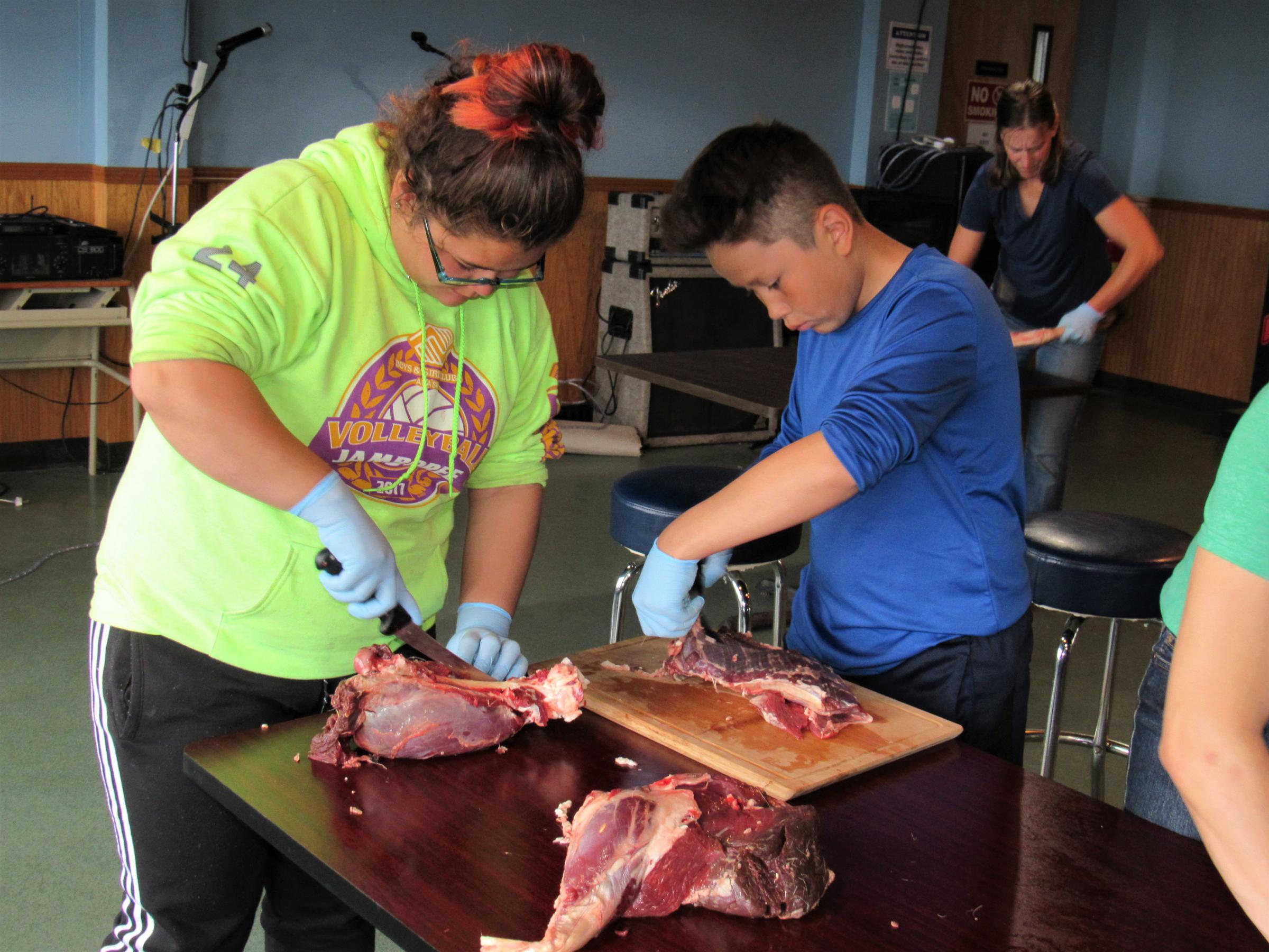 Students at St. Paul’s reindeer camp butcher a female from the island’s herd. This summer, the tribal government organized the camp as part of its effort to develop a more robust reindeer management program. (Photo by Laura Kraegel/KUCB)