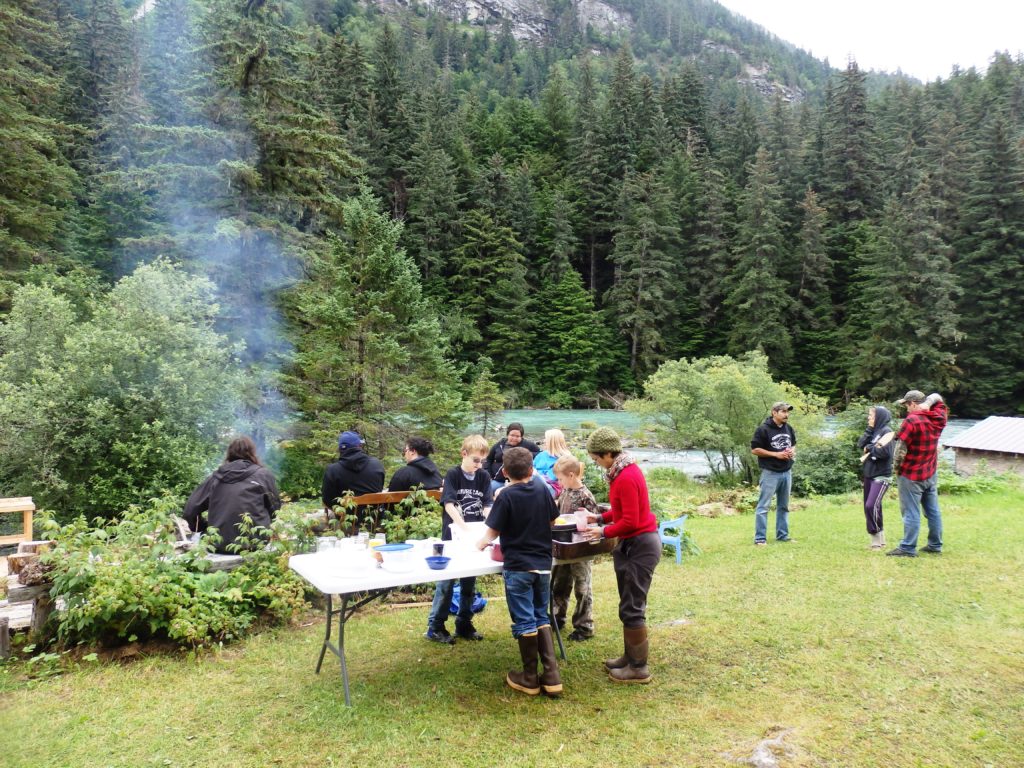 Culture camp participants, friends, and family share a potluck on the last day of the July camp. (Photo by Emily Files/KHNS)
