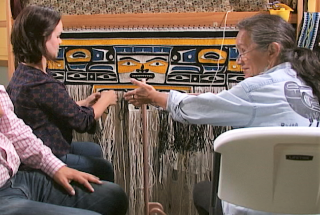 Master Chilkat weaver and multi-disciplinary artist Clarissa Rizal, Daalsak’u Tláa of the T’akhdeintaan clan, weaves with her daughter Lily Hope, Wooshkhindeinda.aat.