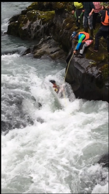 Obadiah Jenkins tries to help Daniel Hartung pull himself from Six-Mile Creek in Hope. (Photo courtesy James Bennett)
