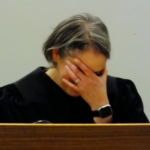 Superior Court Judge Amy Gurton Mead covers her face as family and former coworkers roast her during her installation and robing ceremony Oct. 26, 2018 at the Dimond Courthouse.