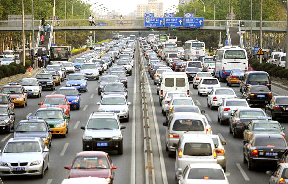 Cars line up in a traffic jam along a road in Beijing on May 12, 2010. Cars line up in a traffic jam along a road in Beijing on May 12, 2010. The number of vehicles registered in Beijing picked up pace in early 2010, government figures showed, putting the Chinese capital on course to have five million cars on the roads by year's end. Photo: LIU JIN/AFP/Getty Images