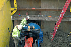 bore101Workers use a diesel engine mounted on a short track to extract another auger from the new tunnel under Wilshire Bl. Workers use a diesel engine mounted on a short track to extract another auger from the new tunnel under Wilshire Bl.