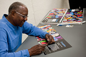 signed posters Artist signs first-edition prints of the Compton poster at the Compton Library program.