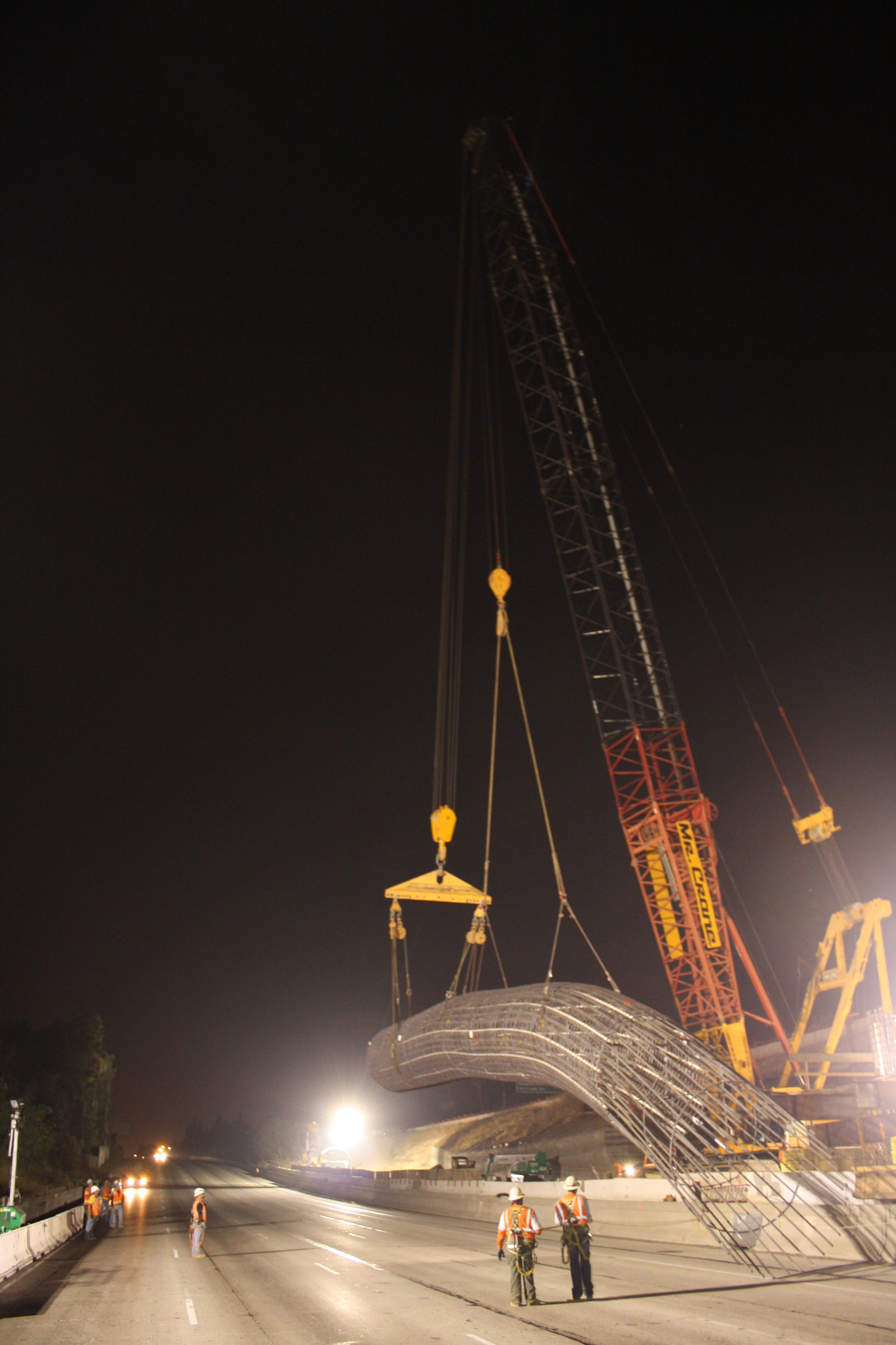 Crane Lifts Reinforcing Steel Cage Into Position