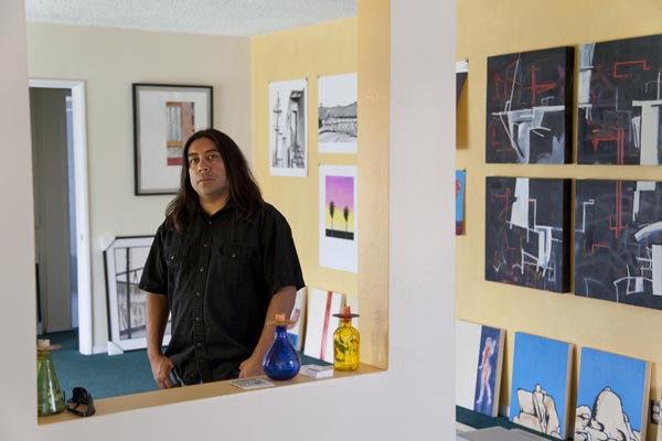 Ramon Ramirez in his Pico Rivera studio. His poster design is visible pinned to the wall behind him.