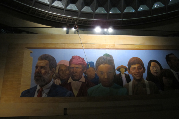 Specialized Metro Art staff work from above the mural in the wee hours, to contain dust particles, and not hinder the flow of transit patrons below.