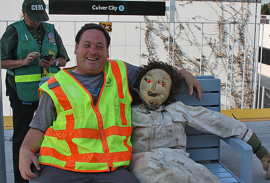 Dwight Sturtevant, aka Expo Line Fan, on the other side of the camera with Metro's crash dummy, Ms. Deb. Photo courtesy of ZevWeb.
