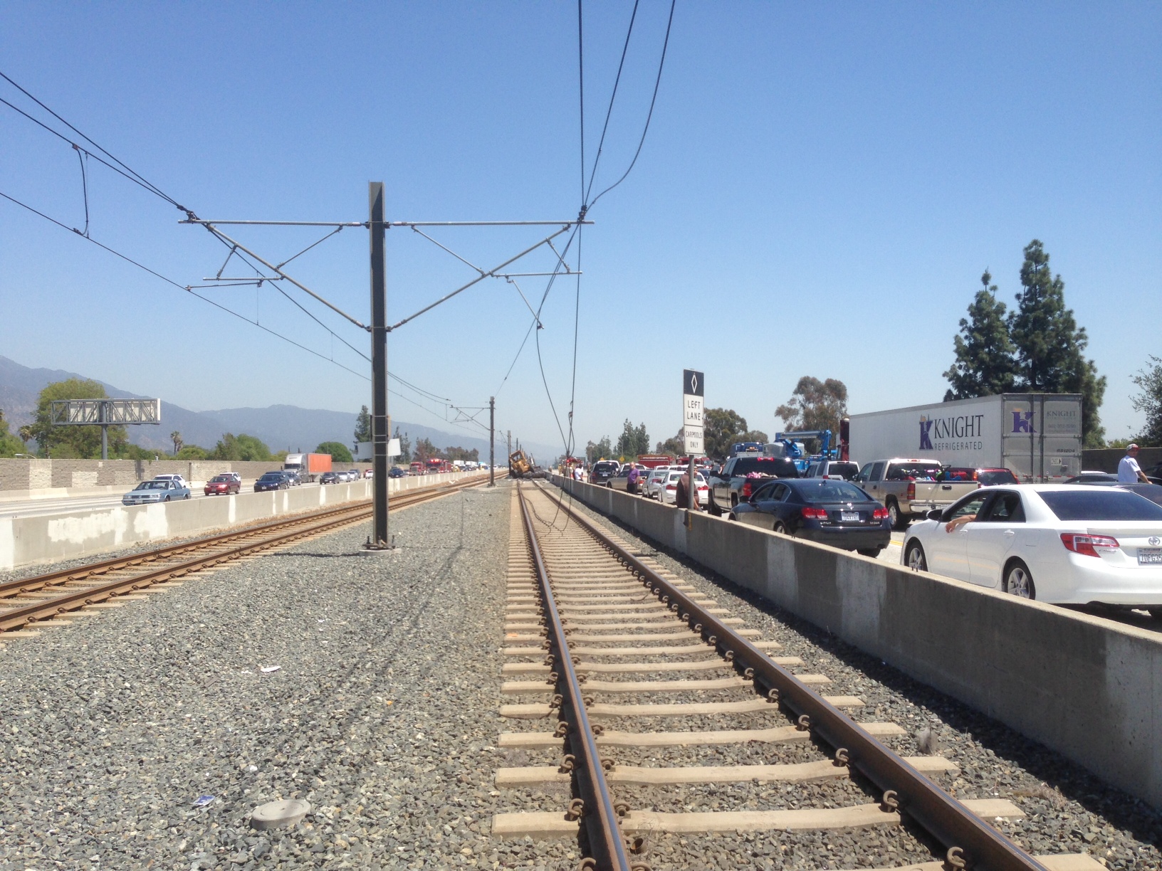 Power supply and support wires droop to the ground after yesterday's big-rig crash. The non-Metro tractor trailer involved in the accident was removed yesterday, but damage to the Gold Line is extensive. (Note the missing cantilevers on the right side of the second and third poles.)