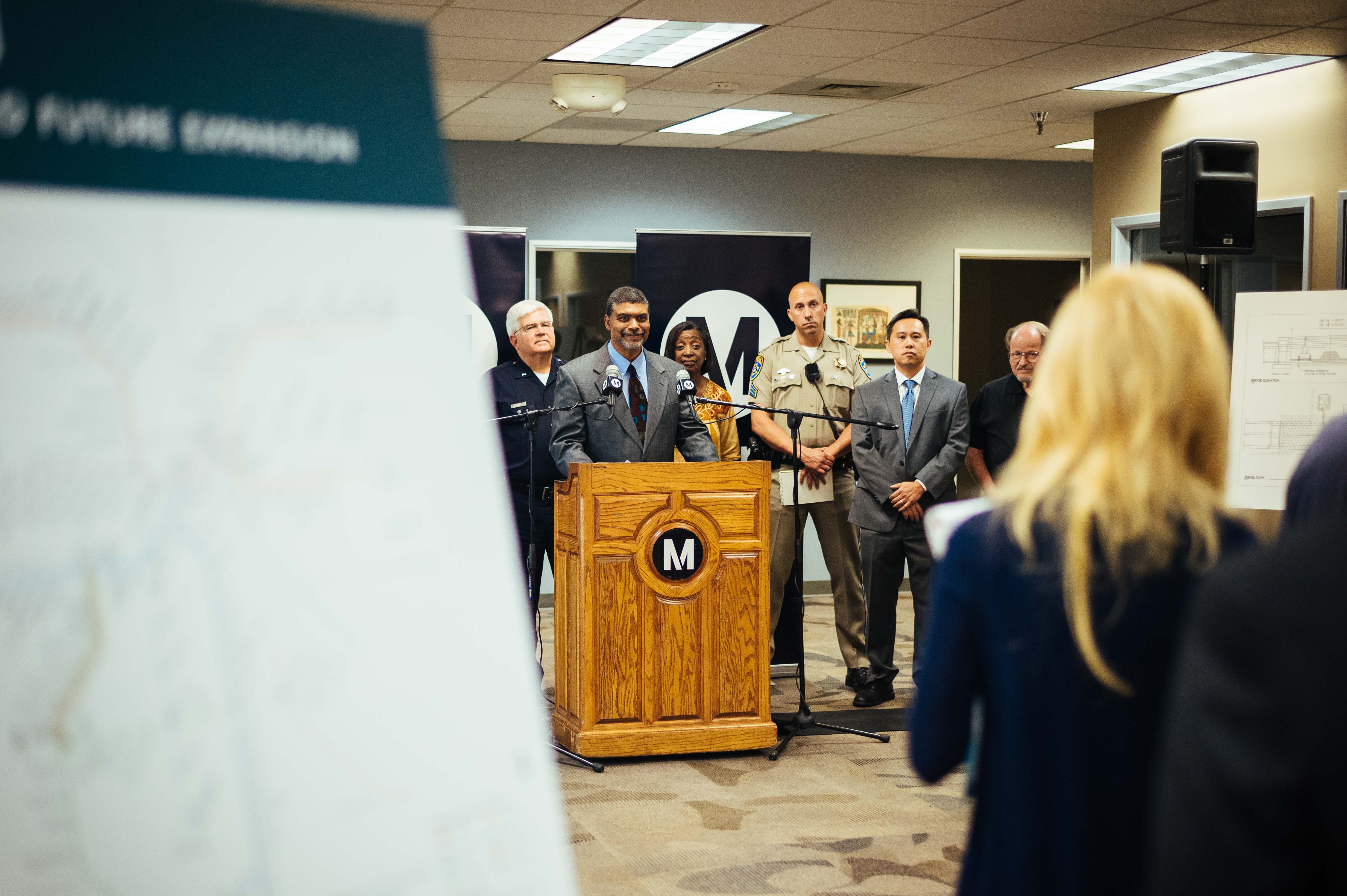 Crenshaw/LAX Line Project Director Charles Beauvoir talks to the media late Friday afternoon; Metro Board Member Jackie DuPont-Walker is behind him.