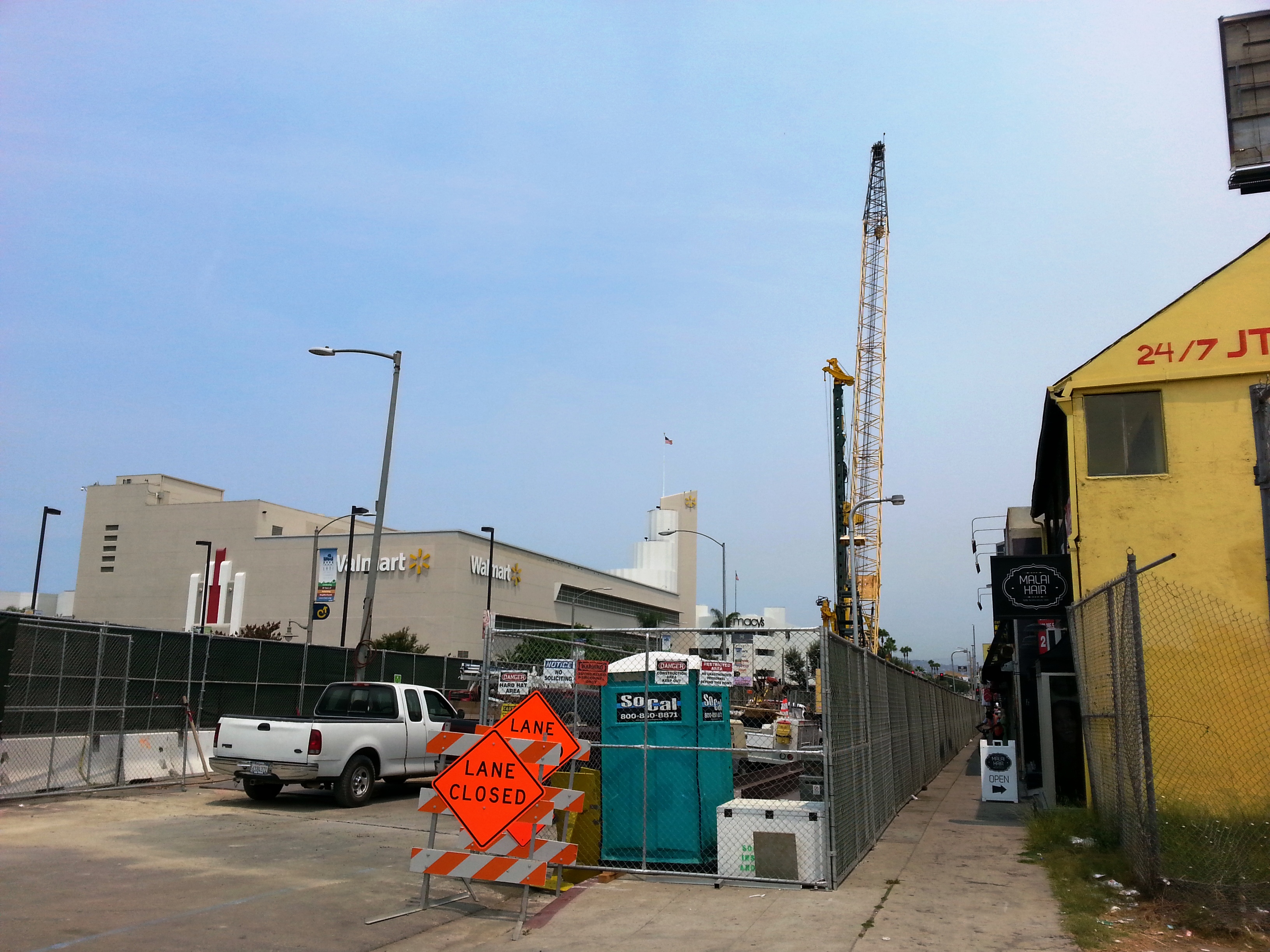 View of construction along Crenshaw Boulevard just north of Stocker Street. There is pedestrian access to businesses.