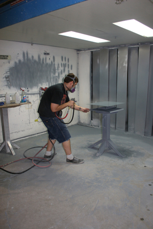 Winsor Fireform technicians preparing the steel and spraying porcelain enamel. Photo courtesy Winsor Fireform.
