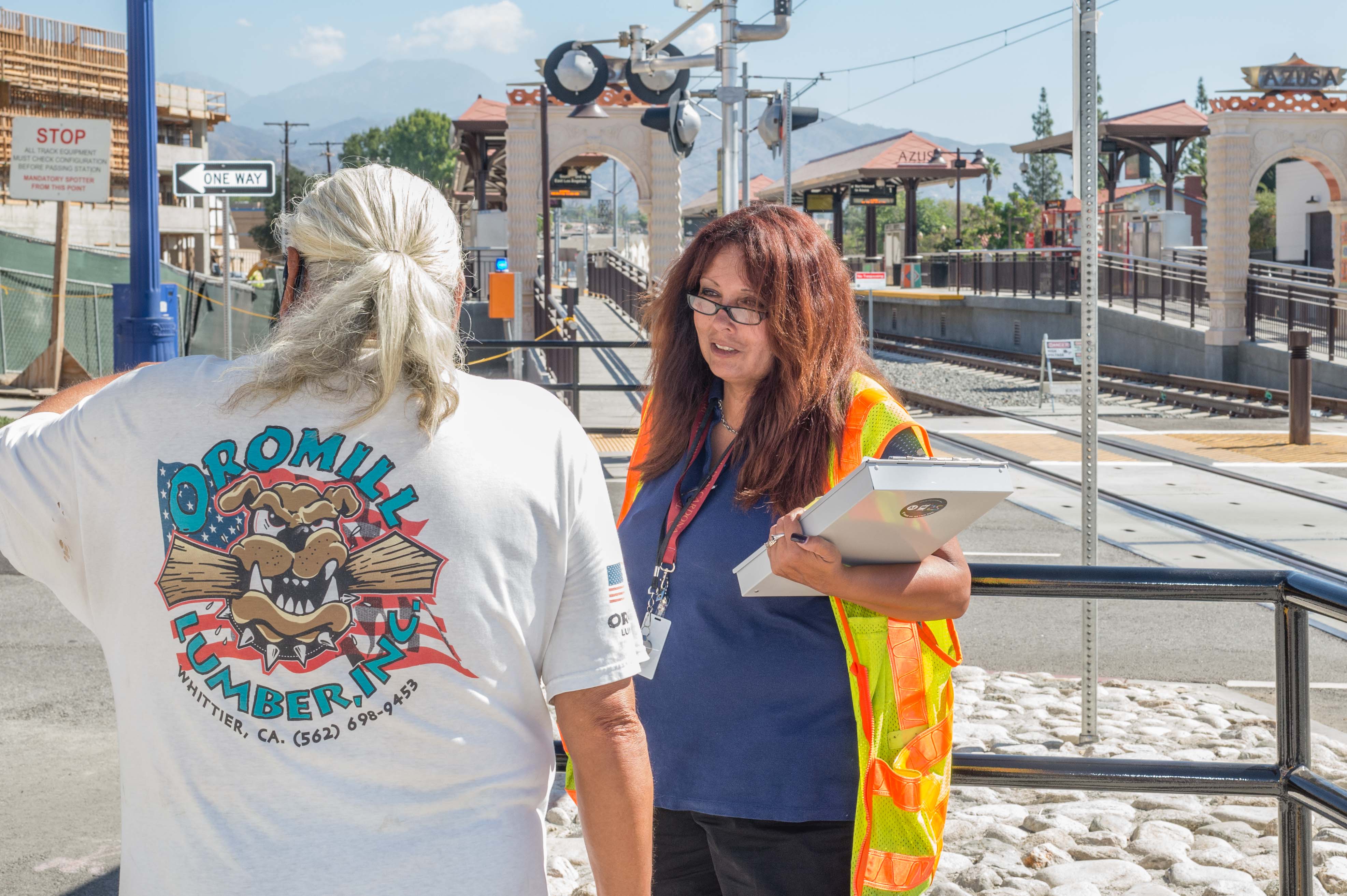 Safety ambassador speaking to a passerby curious about the new Azusa Station. Photo: Steve Hymon/Metro