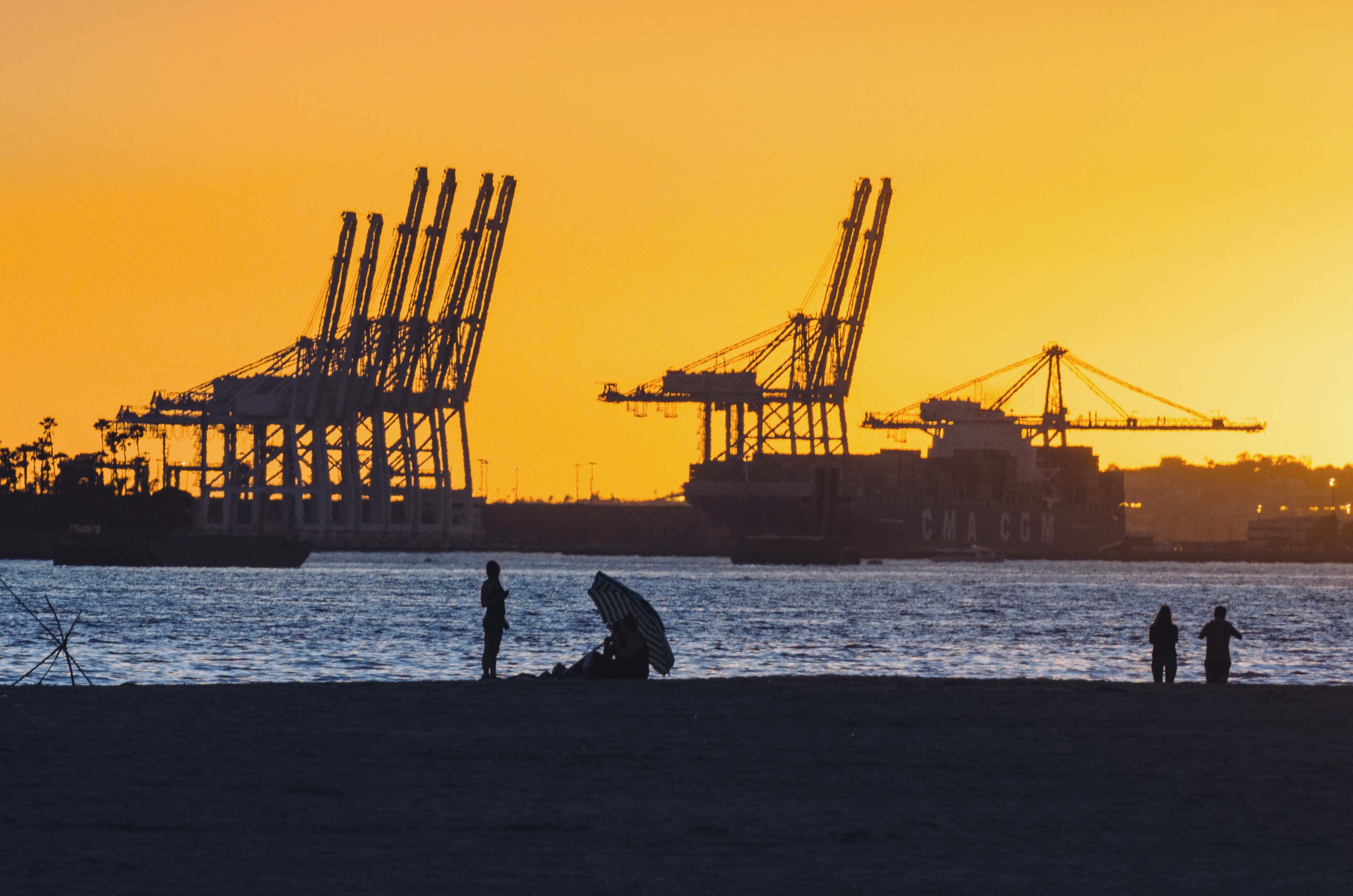 We don't post enough photos about goods movement. Sunset + beach + Port of Long Beach. Photo by Steve Hymon.