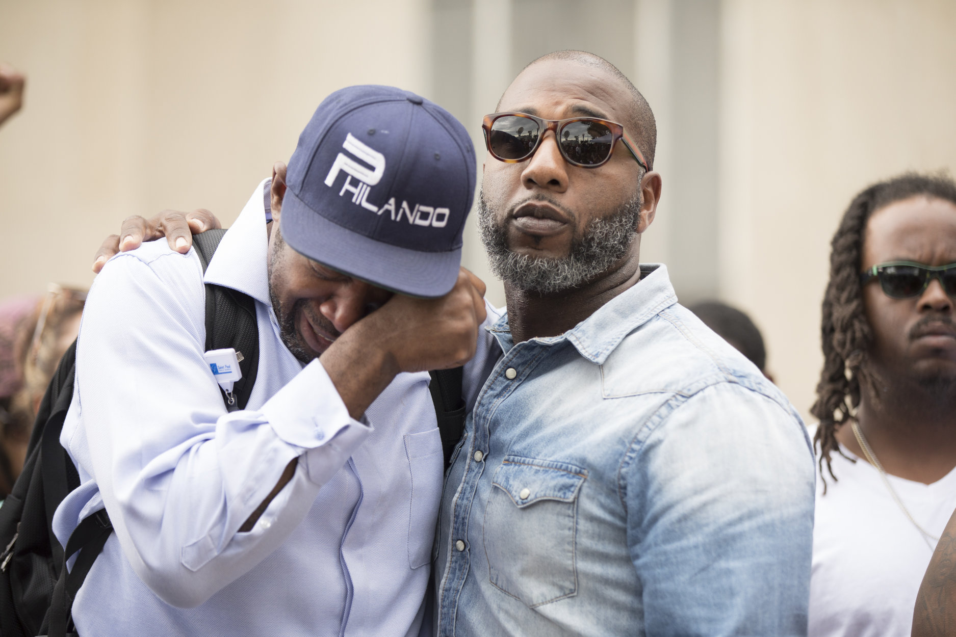 Chris Juhn MSR News John Thompson a friend of Philando Castile’s is consoled by Pastor Danny Givens