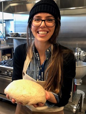Merri Metcalfe holds a ball of dough in the Bread Lab kitchen.