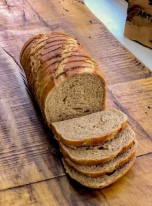Sliced wheat bread on rustic table