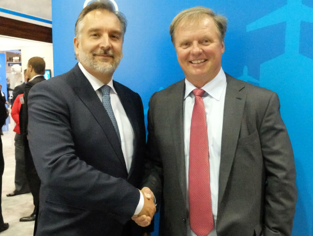 Jim Jensen, founder and CEO of Satcom Direct, right, shakes hands with Mark van Berkel, president and CEO of TrueNorth Avionics, on the NBAA show floor. Ottawa-based TrueNorth has been acquired by Satcom Direct. Lisa Gordon Photo