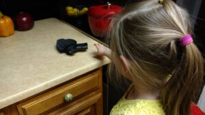 kid reaching for gun