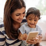 Mother and child playing app on the smartphone
