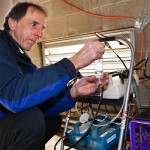 EOHS Research Scientist Tim Gould checks air sampling instruments set up on the roof of the SeaTac Community Center.