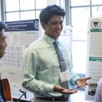 Student presents his research in a poster presentation