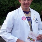 Andrew Heinz distributes health information booklets and talks with visitors at the UW Homecoming Fair.