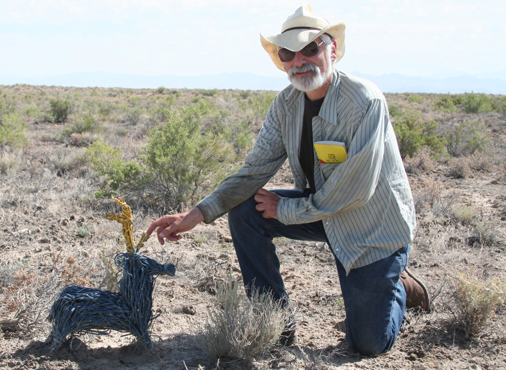 In central Utah, Donald Grayson kneels next to a woven model of the western North American diminutive pronghorn, which became extinct about 11,000 years ago.