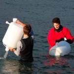 Christian Frazar and David Schruth collect water samples from Puget Sound near Seattle.