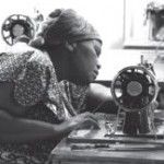 Garment worker using sewing machine
