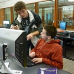 Teaching assistant works with student.