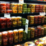 a refrigerator section at a grocery store containing fruit