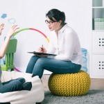 Boy and young woman teacher during private home lesson