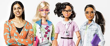 Sapna Cheryan, UW associate professor of psychology, with her Barbie dolls (made to look life size): computer engineer, Katherine Johnson and robotics engineer.