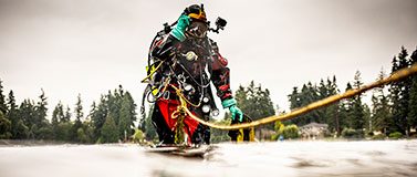 A researcher in scuba gear collects samples from Lake Killarney