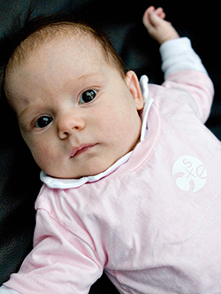 Baby in pink and white CSE onesie
