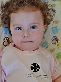 Curly-haired toddler in pink CSE t-shirt