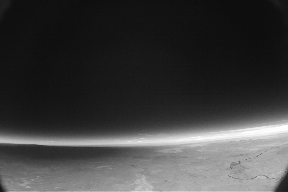 Looking northwest to mid-state Oregon, the camera recorded this image of the moon’s shadow approaching at a speed of 2,000 MPH. The balloon’s altitude at the time of this picture was 43,000 feet, meaning the distance to the horizon is 254 miles, or three times greater than the moon’s diameter of 70 miles. The horizon appears strangely curved in this picture because the camera has a wide-angle lens.