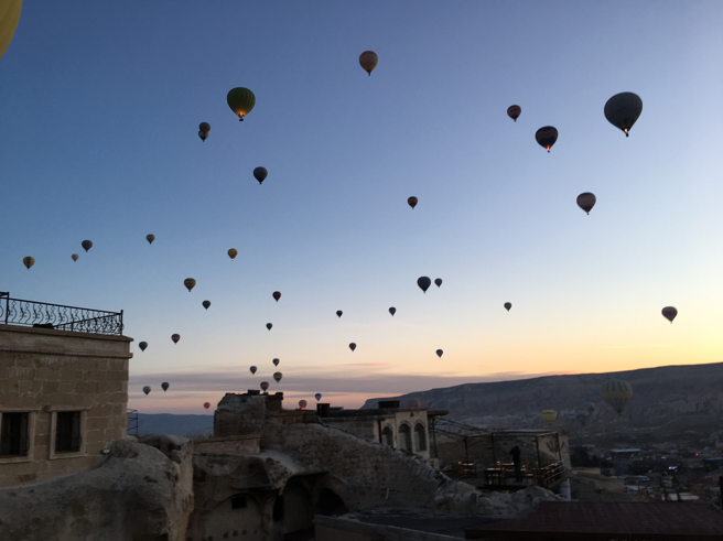 Tourists in Goreme, taking hot air balloon rides: